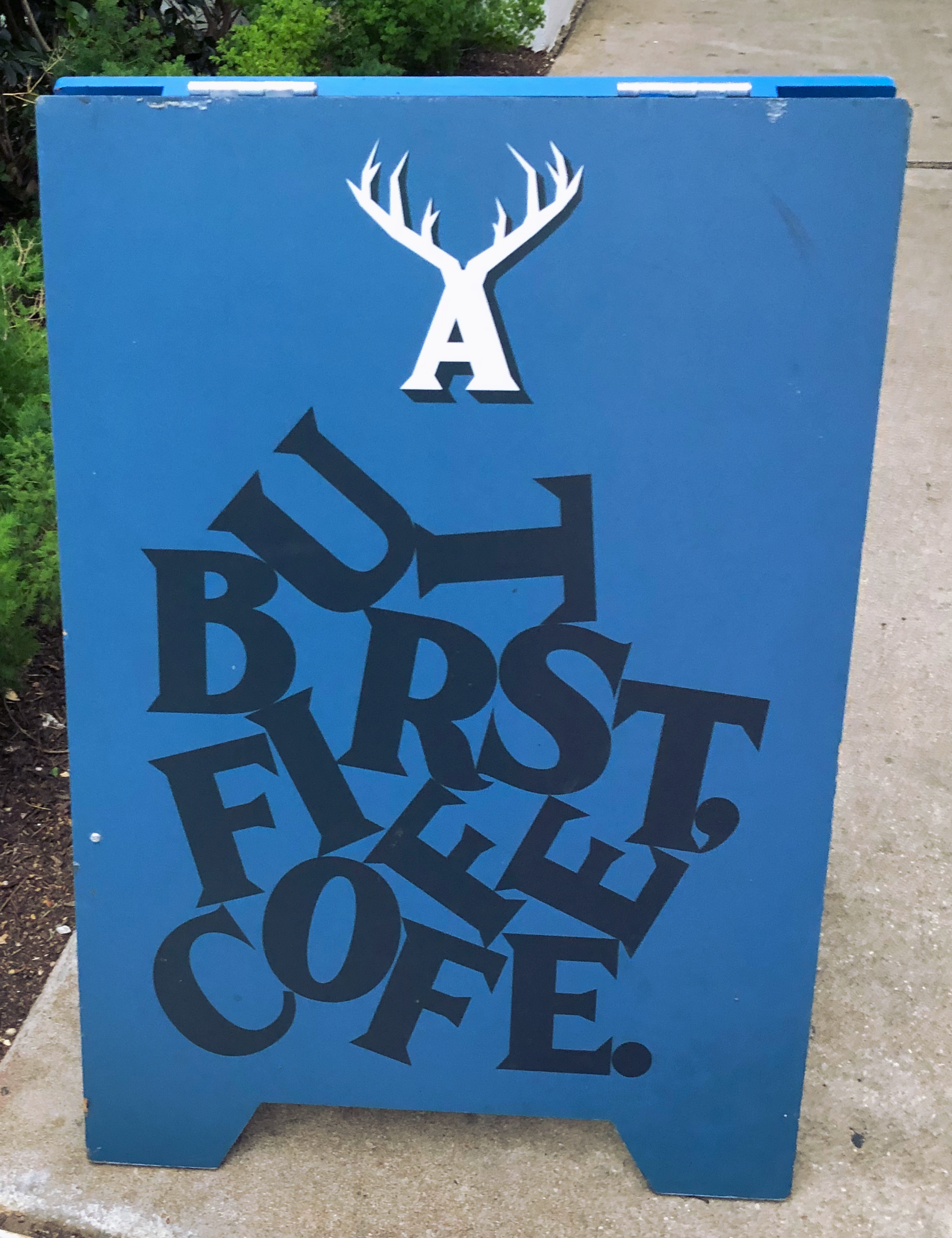 A coffee shop signboard on the streets of Austin