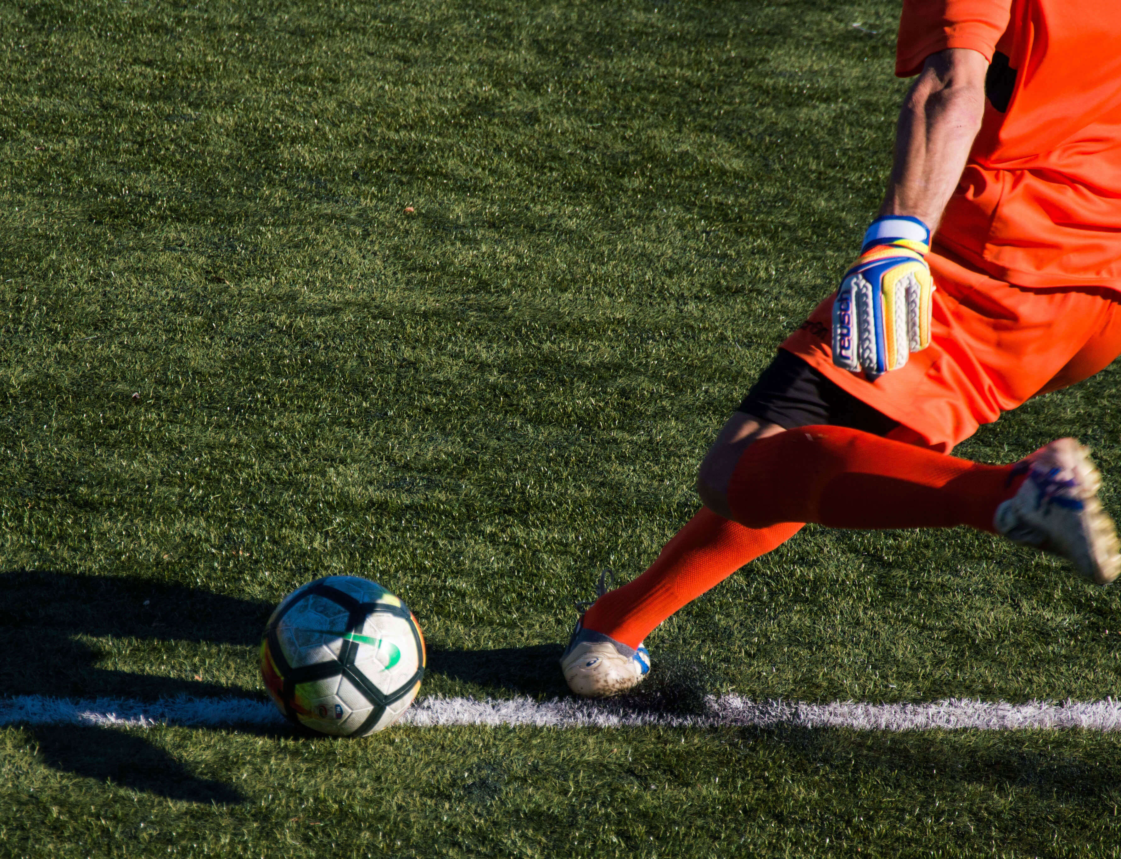 Football player kicks the ball - a stock image from Unsplash