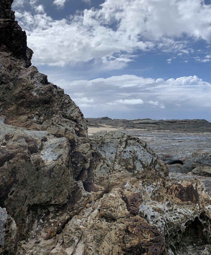 Close up photo of the rock faces by the ocean. ​