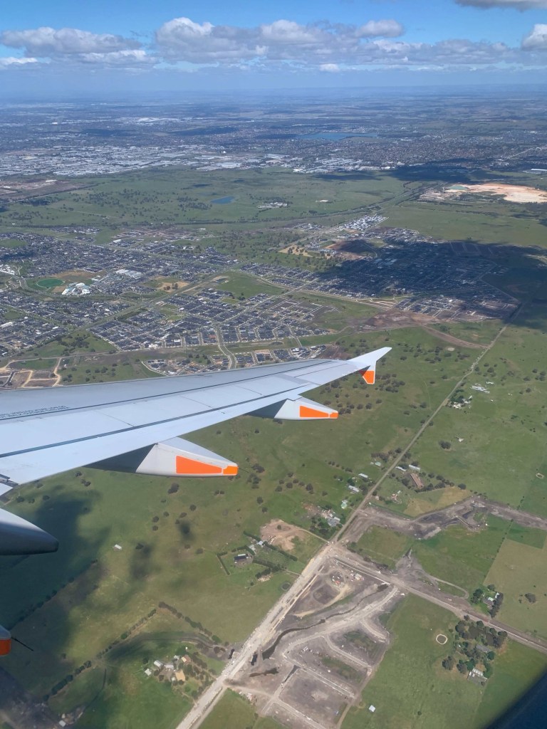 Photo of the Melbourne outskirts as seen from the window seat of a plane that’s starting its descent. 