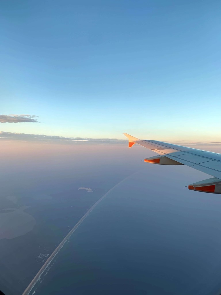 Photo of the Adelaide coast line seen faintly from the window of a plane. 