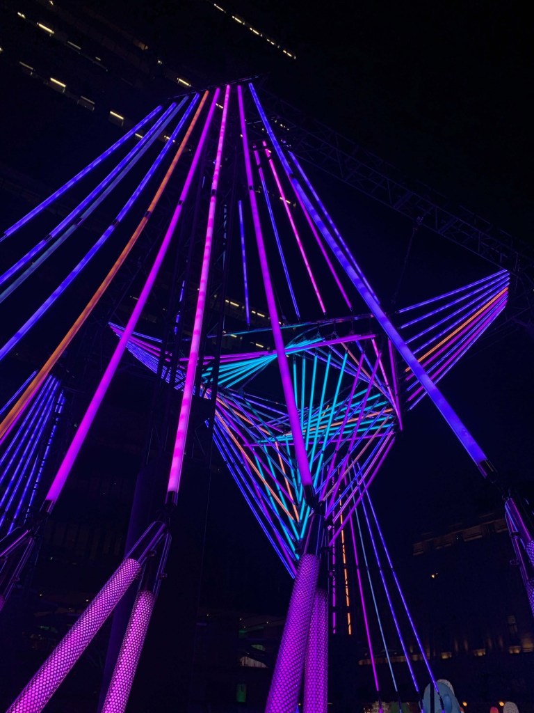 Photo of a light installation with multi-coloured metal rods resembling the light sabres in the Star Wars universe. 