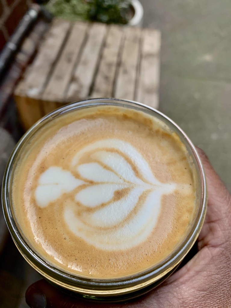 Close up photo of the latte art on a coffee in a keep cup. 
