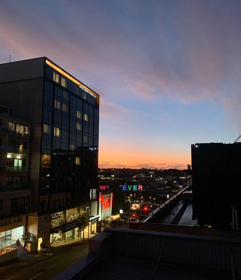 Photo of the horizon at sunset, as seen from a hotel room window. 