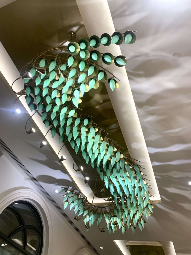 Photo of ceiling lights, made up of little green lights. 