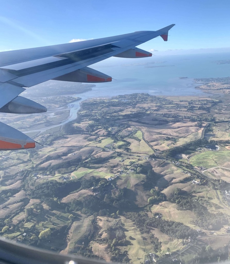Photo of the Auckland landscape as seen from the window of a plane. 