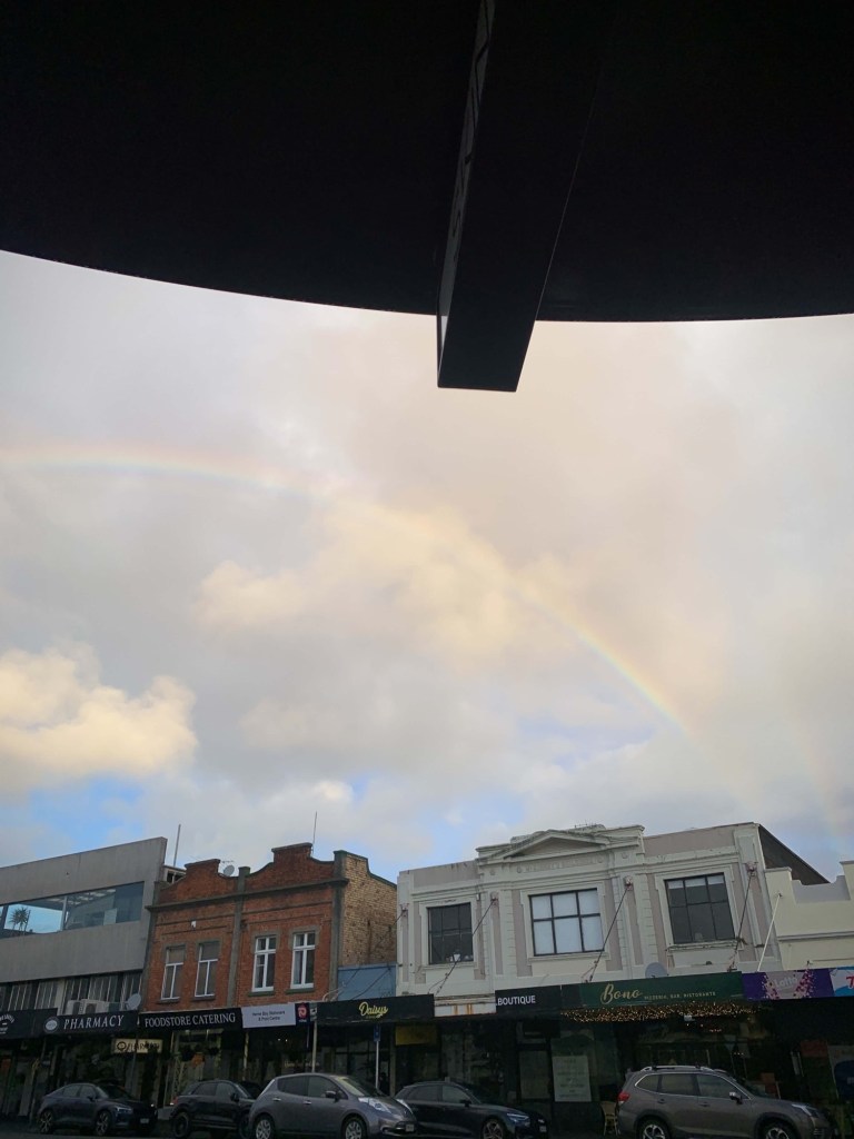 Photo of a rainbow in the sky just after a light rain. 